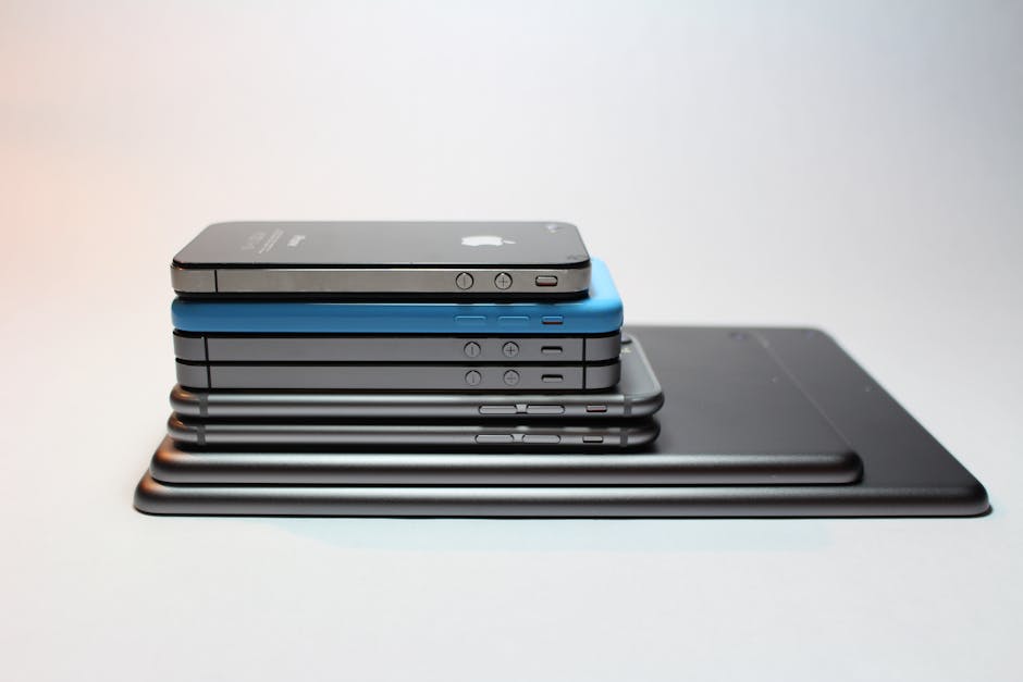 Stacked modern smartphones and tablets showcasing sleek design. Perfect tech background