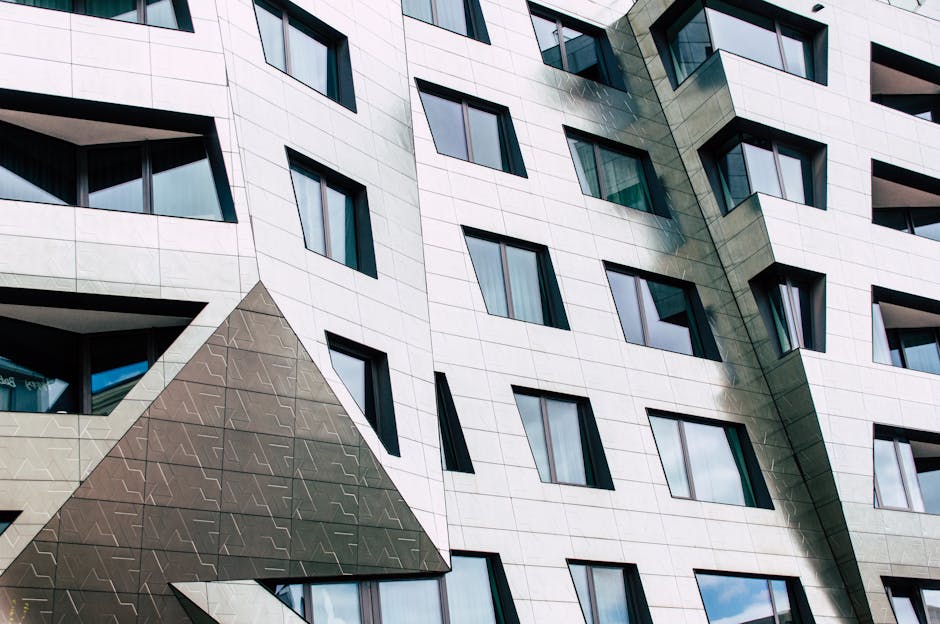 Detailed view of a modern building facade with geometric shapes and reflective windows